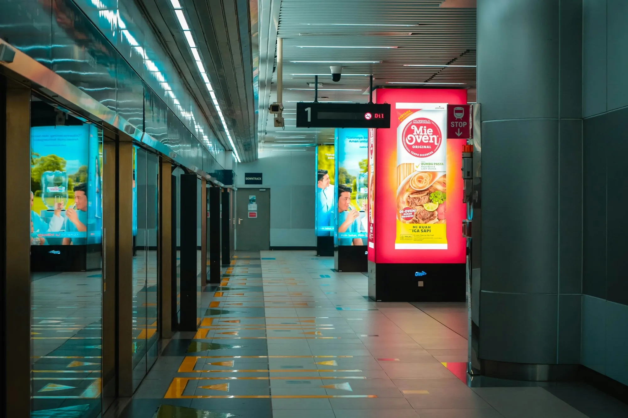 A large advertising display along a commercial concourse